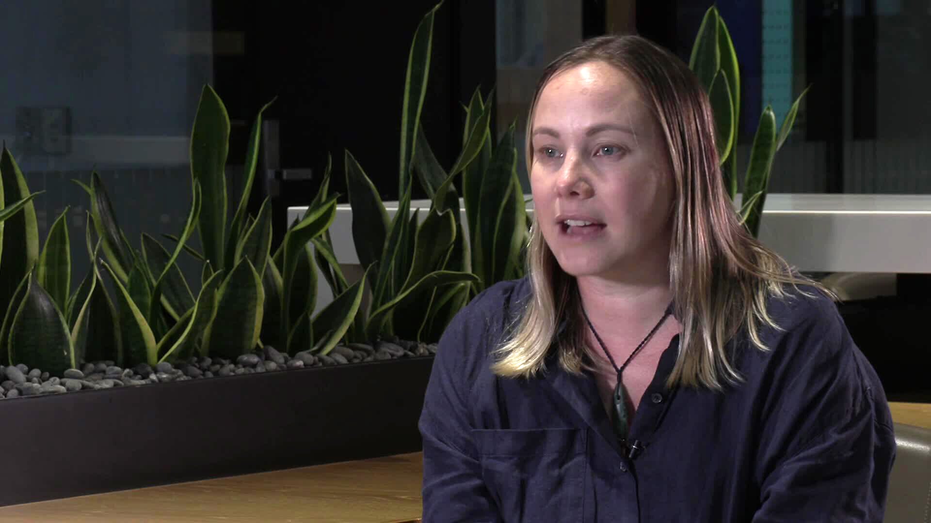 a woman sitting for a video interview