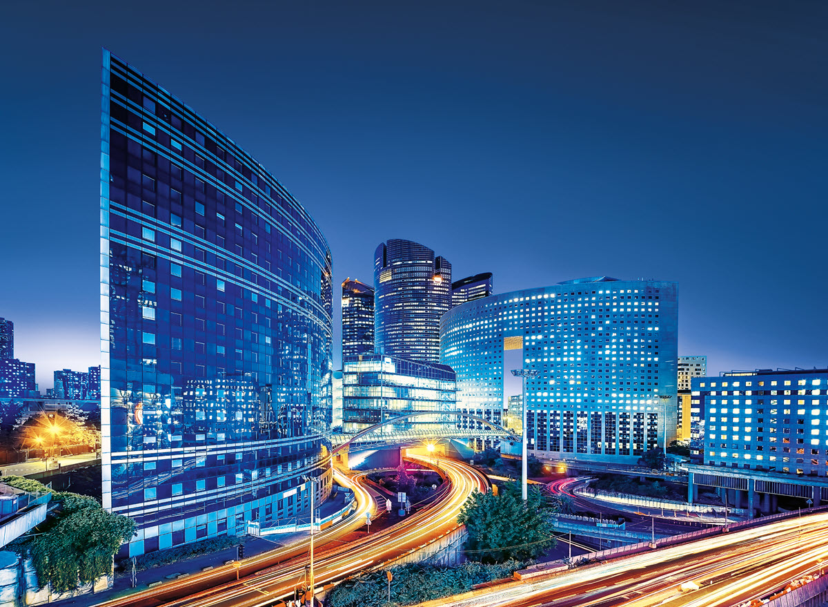 Cityscape with light passing through road